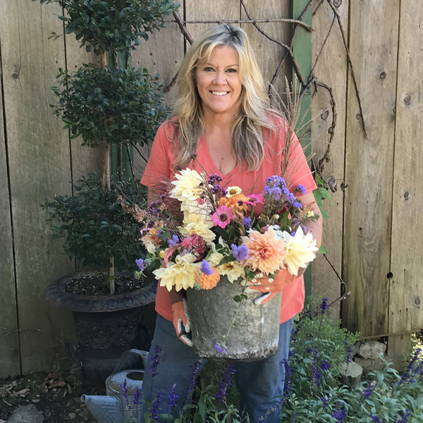Lauren Wise holding a bucket of blooms