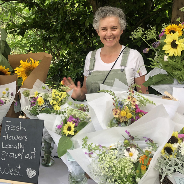 Marisa Vodanovich surrounded by her market bouquets