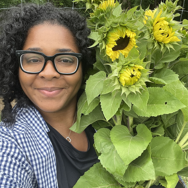 Melanie Wright with an armload of sunflowers