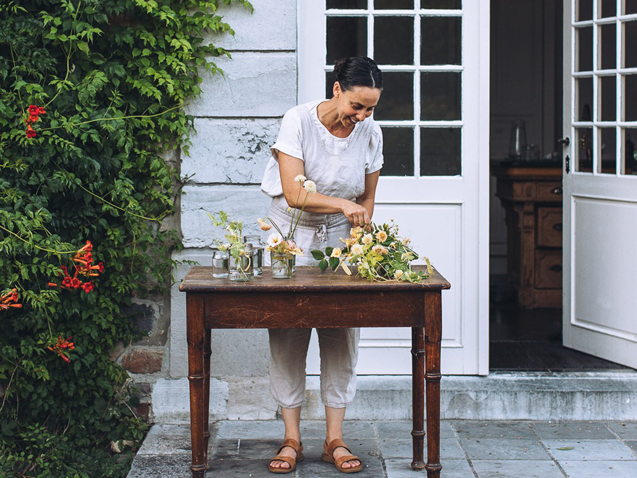 Emily Avenson creating a floral arrangement