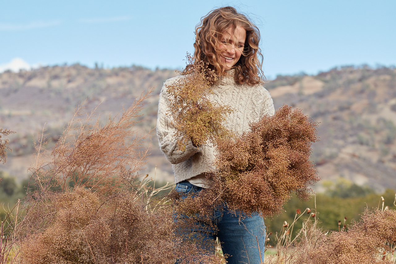 Hannah Muller with an armload of dried blooms