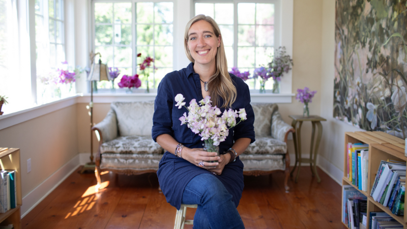 Erin Benzakein holding a bouquet of sweet peas